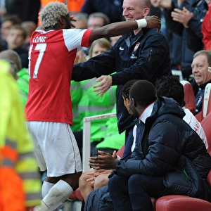 Alex Song celebrates scoring the Arsenal goal with masseur John Kelly. Arsenal 1