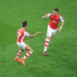 Alexis Sanchez and Mesut Ozil Celebrate Goals: Arsenal FC vs Galatasaray AS, UEFA Champions League, 2014 Alexis Sanchez and Mesut Ozil Celebrate Goals: Arsenal FC vs Galatasaray AS, UEFA Champions League, 2014