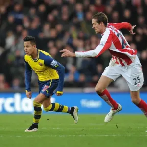Alexis Sanchez Outmaneuvers Peter Crouch: A Moment from the Stoke City vs. Arsenal Premier League Clash (2014-15) Alexis Sanchez Outmaneuvers Peter Crouch: A Moment from the Stoke City vs. Arsenal Premier League Clash (2014-15)
