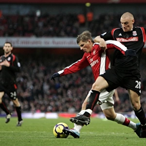 Andrey Arshavin holds off Andy Wilkinson (Stoke) on his way to scoring Arsenals 1st goal