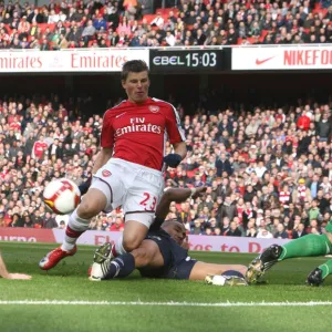 Andrey Arshavin looks on as Andre Ooijer puts through