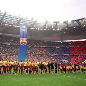 The Arsenal and Barcelona players line up before the match