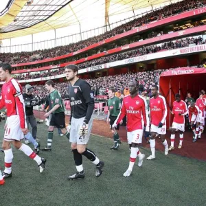 Arsenal captain Robin van Persie leads out the team