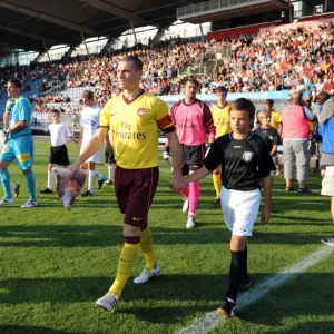 Arsenal captain Thomas Vermaelen leads the team out before the match. Sturm Graz 0 Arsenal captain Thomas Vermaelen leads the team out before the match. Sturm Graz 0