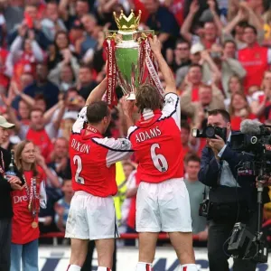 Arsenal captain Tony Adams and Lee Dixon hold the Premiership trophy after the match