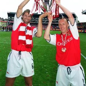 Arsenal captain Tony Adams and Lee Dixon lift the F. A