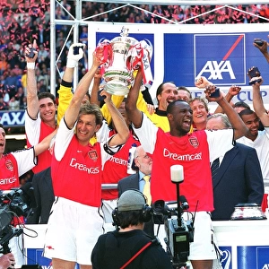 Arsenal captain Tony Adams and vice-captain Patrick Vieira lift the FA Cup