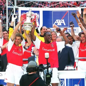 Arsenal captain Tony Adams and vice-captain Patrick Vieira lift the FA Cup