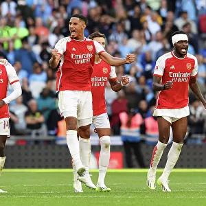 Arsenal Celebrate Community Shield Victory: Arsenal Players, Including William Saliba, Rejoice after Defeating Manchester City (2023-24)