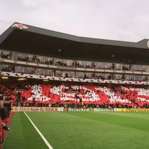 Arsenal fans in the Clock End hold up cards that read 1913