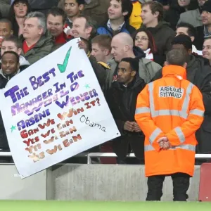 Arsenal fans show a flag in support of Arsene Wenger