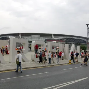 Arsenal fans gather around the giant letters near the south bridge outside the Emirates Stadium