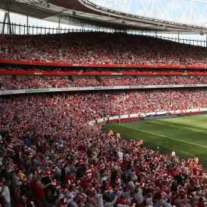 Arsenal fans hold up their scarves before the match