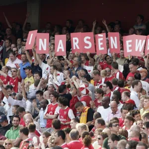 Arsenal fans hold up a sign in support of Arsene Wenger