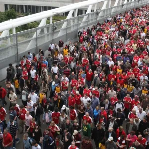 Arsenal fans make their way home after the match crossing