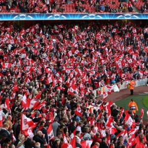 Arsenal fans wave their flags before the match