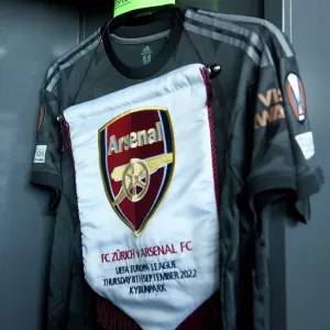 Arsenal FC Prepares for UEFA Europa League Clash against FC Zurich: Match Pennant and Captains Armband in the Changing Room