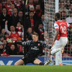 Arsenal goalkeeper Wojciech Szczesny closes down Barcelona forward Lionel Messi