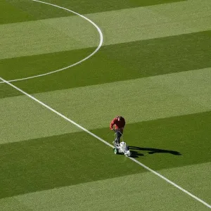Arsenal Groundsman Meticulously Prepares Emirates Stadium Pitch for Carabao Cup Match