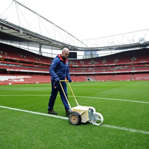 Arsenal Groundsman Prepares Pitch for FA Cup Match against Hull City