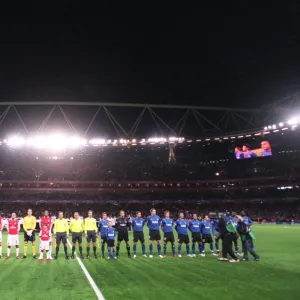 The Arsenal and Hamburg teams line up before the match