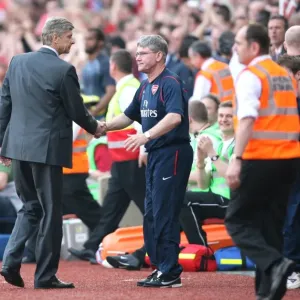 Arsenal manager Arsene Wenger and assistant Pat Rice shake hands after the match