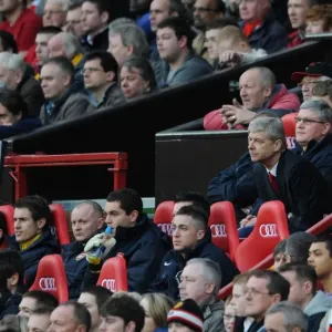 Arsenal Manager Arsene Wenger and his Assistant Pat Rice sit on the bench