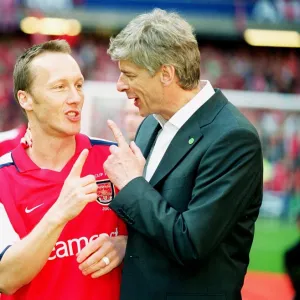 Arsenal manager Arsene Wenger with defender Lee Dixon after the match