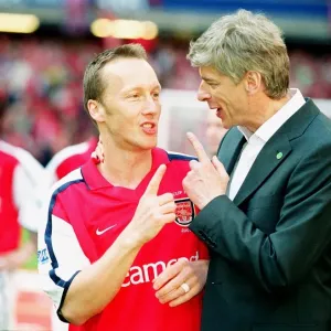 Arsenal manager Arsene Wenger with defender Lee Dixon after the match