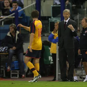 Arsenal manager Arsene Wenger talks to Aaron Ramsey during the match