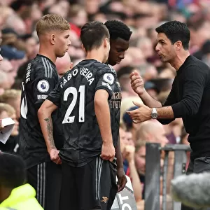 Arsenal Manager Mikel Arteta Conferring with Substitutes during Manchester United vs Arsenal (2022-23)