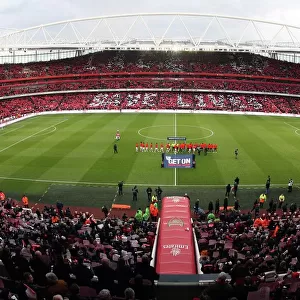 Arsenal and Manchester United shakes hands as the fans hold up Lace Up Save Lives cards