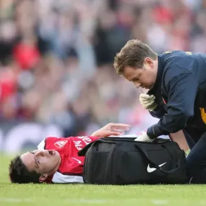Arsenal physio Colin Lewin with injured Samir Nasri