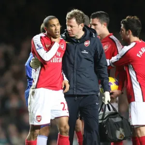 Arsenal physio Colin Lwein treats Gael Clichy