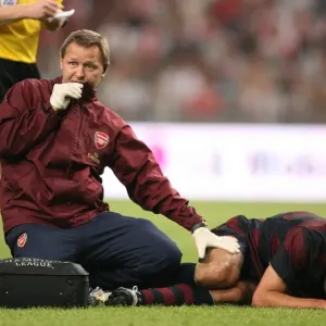 Arsenal physio Gary Lewin treats the injured Robin van Persie Arsenal physio Gary Lewin treats the injured Robin van Persie