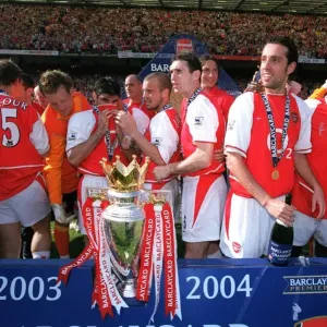 The Arsenal Players celebrate with the Premiership trophy The Arsenal Players celebrate with the Premiership trophy