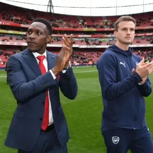 Arsenal Players Danny Welbeck and Rob Holding Celebrate with Fans after Victory over Brighton & Hove Albion