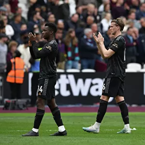 Arsenal Players Eddie Nketiah and Rob Holding Celebrate with Fans after West Ham Victory