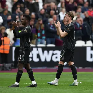 Arsenal Players Eddie Nketiah and Rob Holding Celebrate with Fans after West Ham Victory