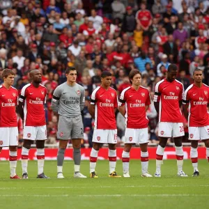 The Arsenal players line up for a minutes applause