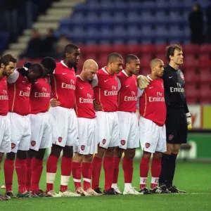 The Arsenal players line up for a minutes silence before the match
