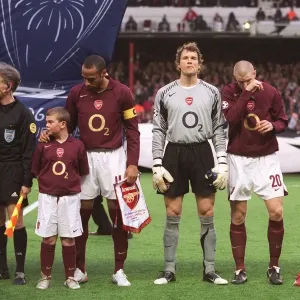 The Arsenal players line up before the mtch