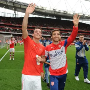 Arsenal Players Mesut Ozil and Mathieu Flamini Waving to Fans after Arsenal vs. West Bromwich Albion Match (2014/15) Arsenal Players Mesut Ozil and Mathieu Flamini Waving to Fans after Arsenal vs. West Bromwich Albion Match (2014/15)