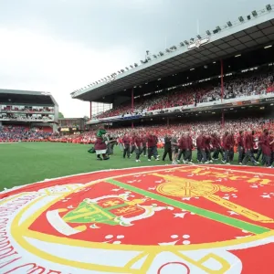 The Arsenal squad wave to the fans during the final salute parade