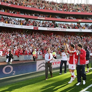 The Arsenal squad wave to the fans after the match