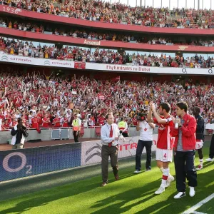 The Arsenal squad wave to the fans after the match