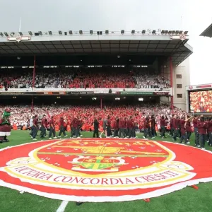 The Arsenal Squad wave to the fans from the pitch during the final salute parade