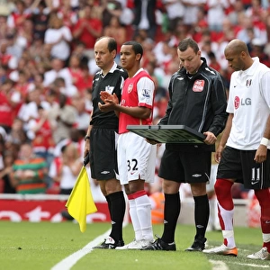 Arsenal substitute Theo Walcott waits to come on
