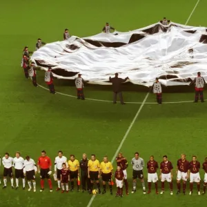 The Arsenal team line up before the match with the Champions League banner behind them