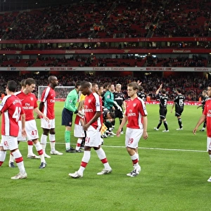 The Arsenal team walk out onto the pitch before the match